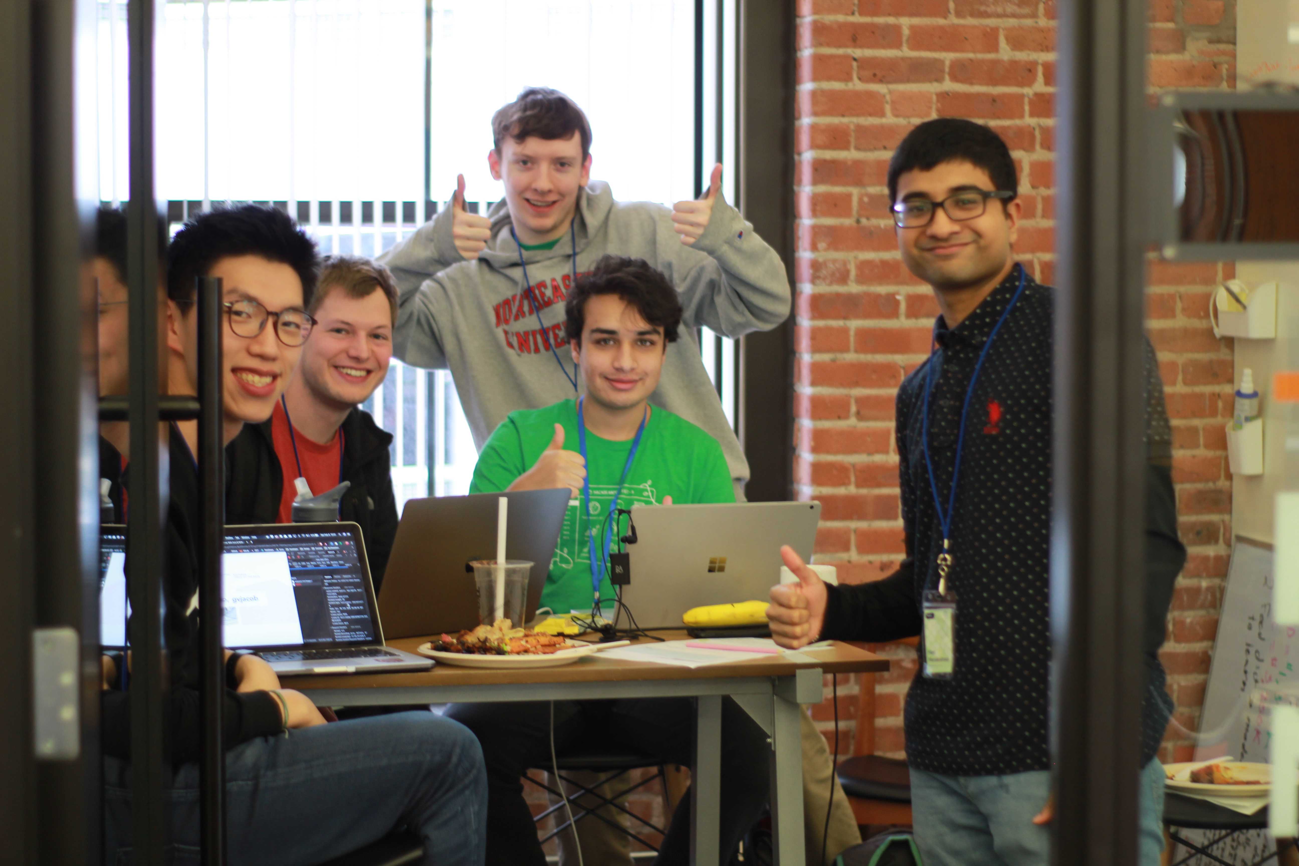 a few hackers giving a thumbs up to the camera